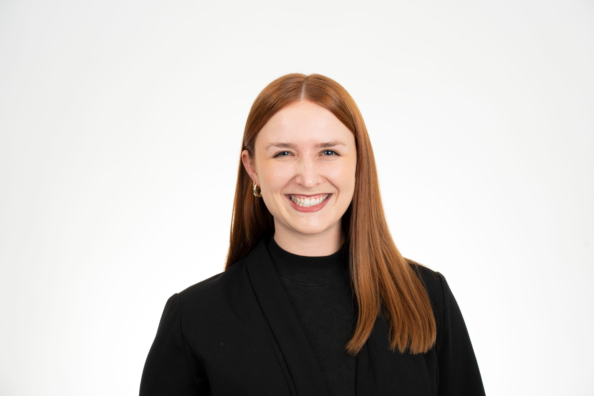 Professional headshot of a smiling woman against a clean studio backdrop