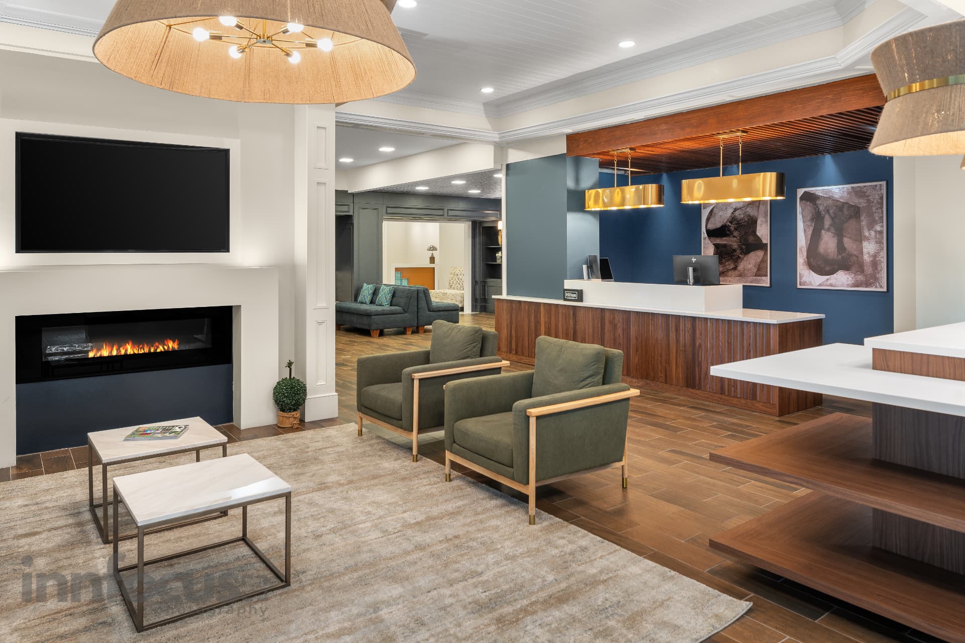 Contemporary hospitality lobby with reception desk and fireplace